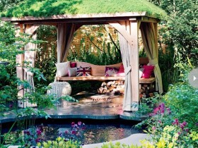 A wooden gazebo with green roof
