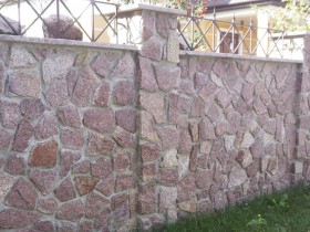 Stone fence on a country site