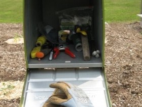 Use a mailbox to store garden tools