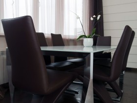 Белая столовая с черными стульями в квартире