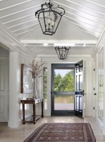 Large white hallway with black chandeliers