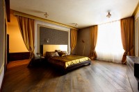 Golden bed in a spacious bedroom