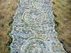 Garden path made of pebbles with their hands