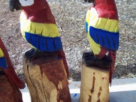 A garden figure of a parrot with his own hands