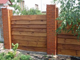 A fence of brick and wood