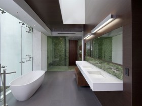 Ванная комната с деревянной отделкой стен и белой ванной